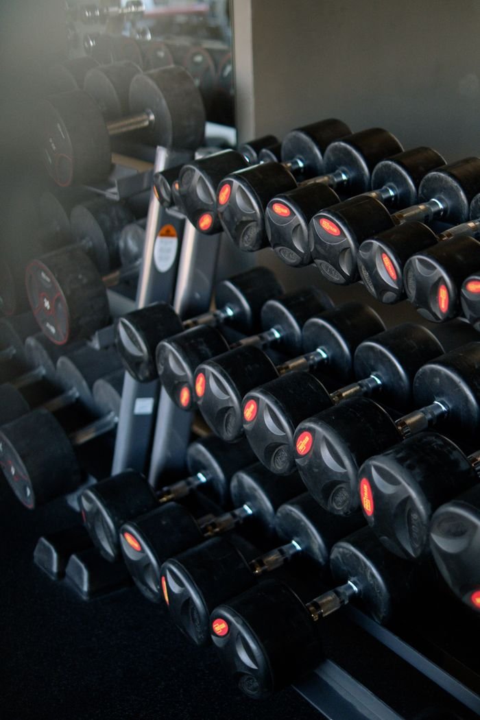 The Art of Drawing Readers In: Your attractive post title goes here A neatly arranged set of dumbbells in a fitness center gym, ideal for strength training.